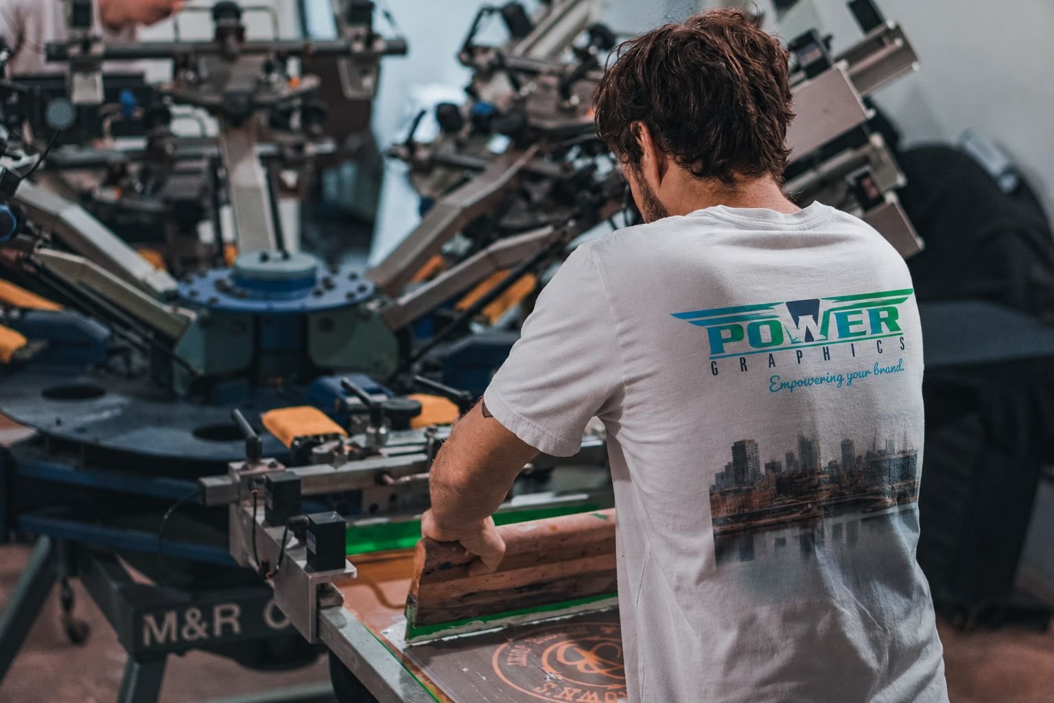 Screen printing press in action at the Power Graphics shop in Hillside Plaza