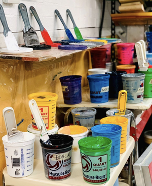 Inks and supplies on the production bench at Power Graphics